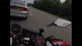 Car cuts the road of a biker, police instantly intervenes