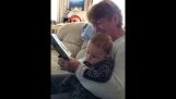 A grandma is having fun reading a story to her grandson