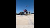 Jumping on a motorcycle over a plane