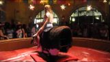 Girl riding a mechanical bull