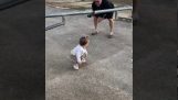 A little girl passes under a barrier