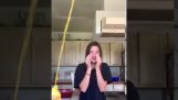 Girl opens a bottle of mustard in the kitchen