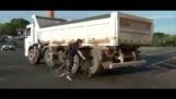Woman on bicycle almost get run over by truck