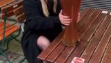 A girl drinks a big beer