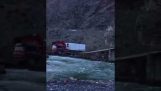 Large Truck Carries House Over Tiny Wooden Bridge