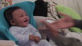 A baby chuckles when his dad is rapping