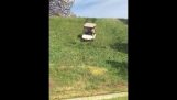 A golf cart going downhill