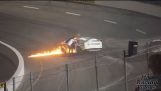A father saves his son from a burning car on a racetrack