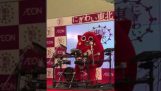 Japanese mascot performing death metal drumming for a children’s song.