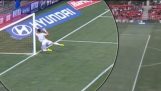 A goalkeeper hits his pole violently