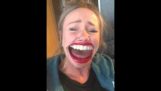 A woman laughs by filming with the application Face Swap Live
