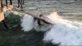 Overturning a sailing boat by strong waves