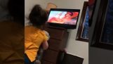 A little girl watches “The Lion King”