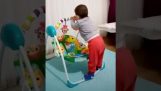 A clever baby uses a child's swing