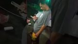 Drunk man checking his mobile phone