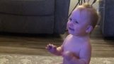 A baby makes a bottle flip