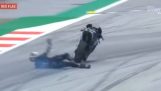 A MotoGP driver jumps off his motorcycle