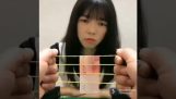 Magic trick with a rubber band and a banknote