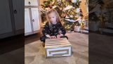 A blind girl opens a very nice gift