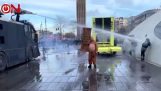 Water cannon hits a woman