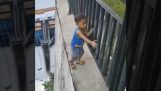 Parent records his child on the wall of a dam